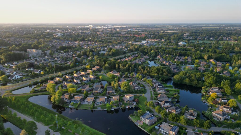 Drone view of Heidemeer in the city Heerenveen surrounded by a river and greenery in the Netherlands